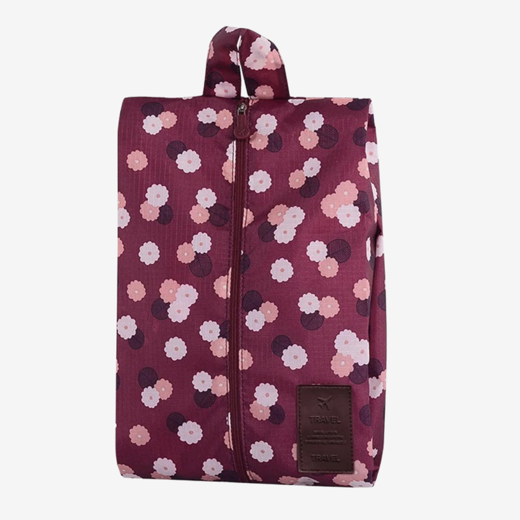 Pochette de rangement bordeaux à motif floral, fermeture éclair verticale, poignée en haut et écusson « TRAVEL »