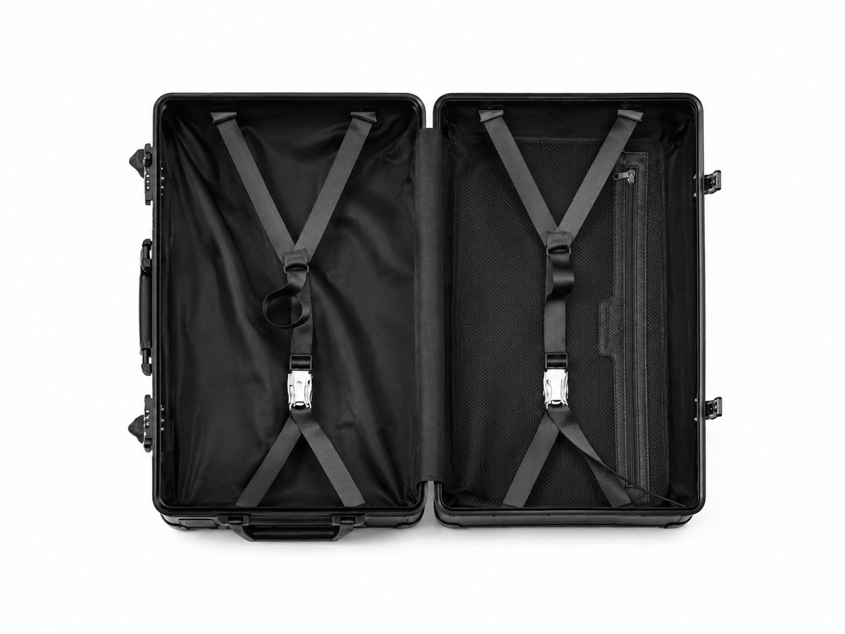 Valise Orvessa Rivoli ouverte à plat : deux compartiments noirs avec sangles croisées et poche zippée